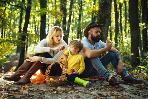 Snack time. Basket picnic healthy food snacks fruits. Mother father and small son picnic. Picnic in nature. Vacation and tourism concept. Happy family with kid boy relaxing while hiking in forest
