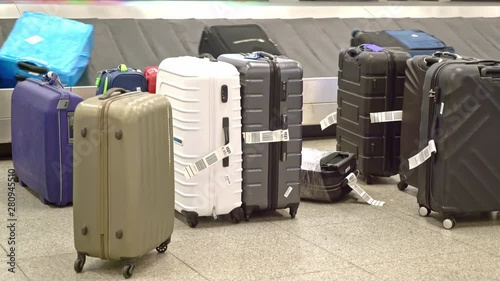 New York, United States, June 10, 2018: Luggage on baggage carousel waiting for travelors at the depature hall of John F. Kennedy airport photo