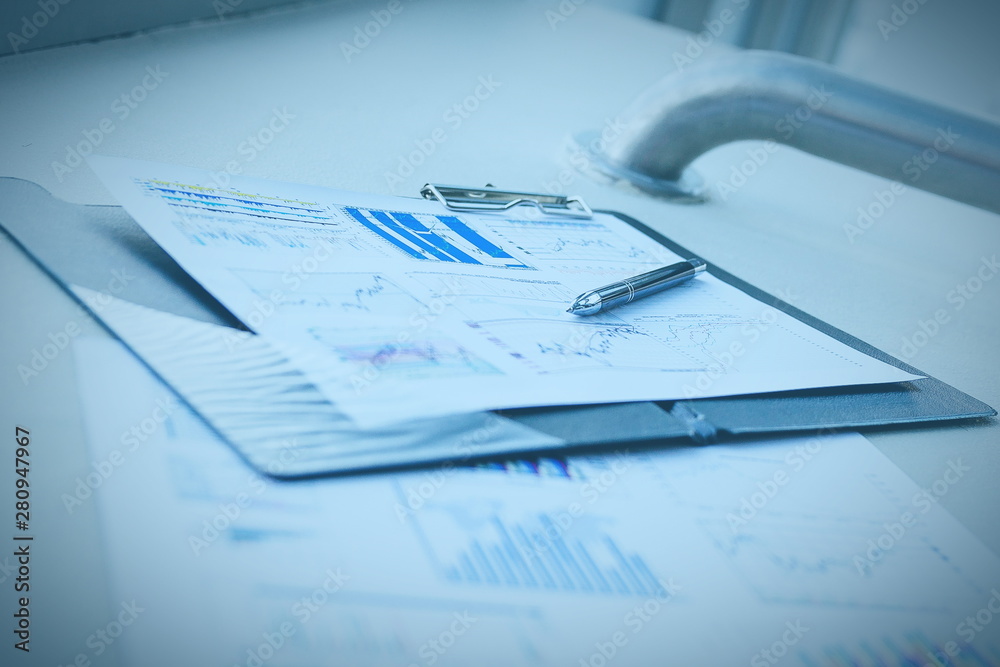 pen and financial documents on the desktop in the office pen and financial documents on the desktop in the office