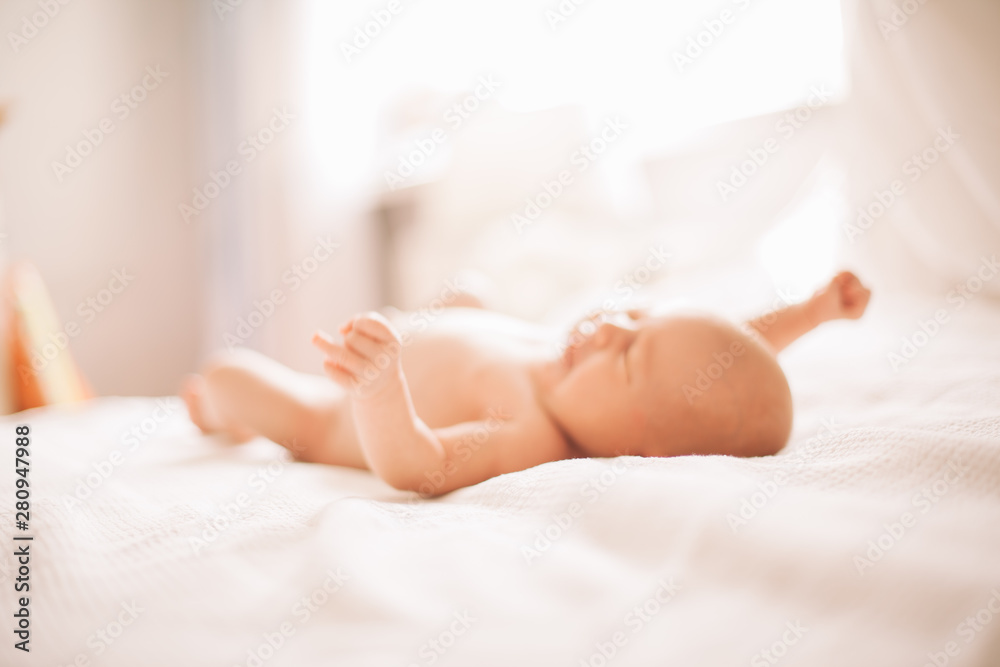 portrait of a pretty newborn baby lying on the bed. photo with copy space portrait of a pretty newborn baby lying on the bed. photo with copy space