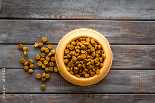 Fototapeta Naklejka Na Ścianę i Meble -  Dry pet food in bowls on wooden background top view