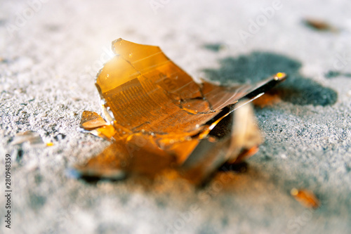 Canvas Print A broken bottle lies on the road. Dangerous glass shards