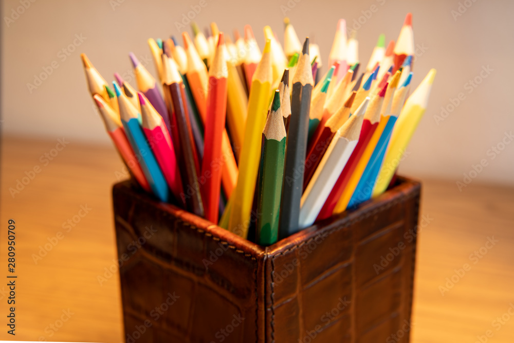 Selection of colored sharpened pencils standing upright in a box Selection of colored sharpened pencils standing upright in a box