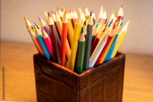 Selection of colored sharpened pencils standing upright in a box