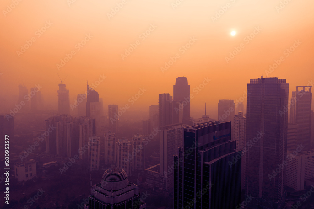 Air pollution covering Jakarta city at sunset