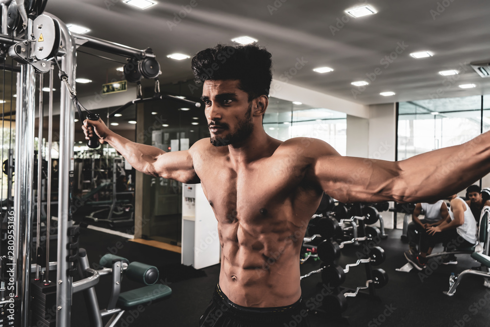 Bodybuilder Is Working On His Chest With Cable Crossover In Gym. Scream for motivation