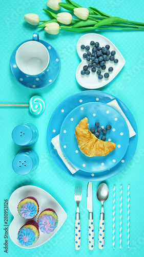 Modern bright colorful blue theme morning breakfast or brunch table setting, flat lay.