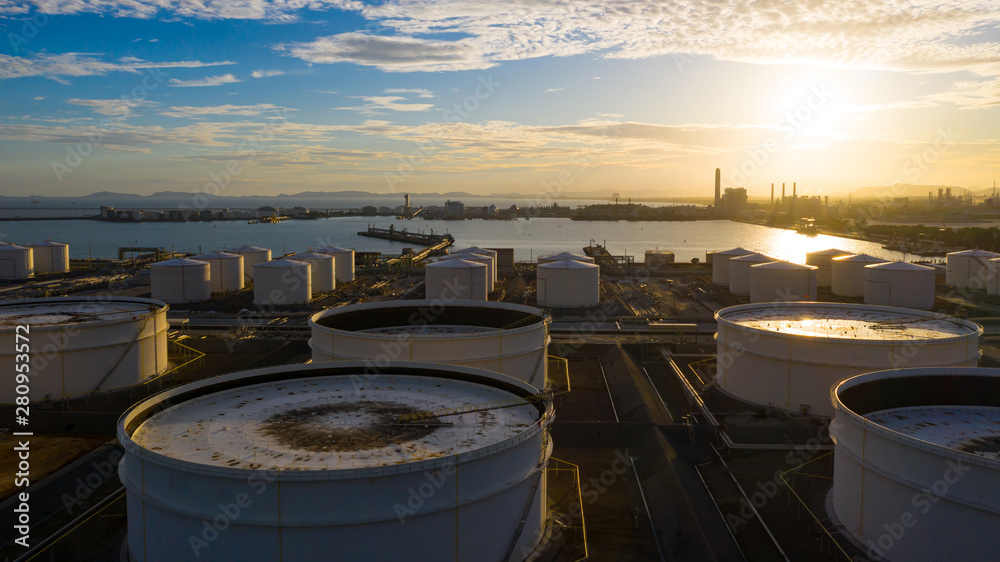 Aerial view of tank terminal with lots of oil storage tank and petrochemical storage tank at sunset, Industrial tank storage aerial view. Aerial view of tank terminal with lots of oil storage tank and petrochemical storage tank at sunset, Industrial tank storage aerial view.