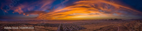 Panoramic aerial view of a desert community in Arizona during the golden hour at sunset.