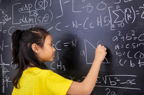 Female student writes mathematics formula