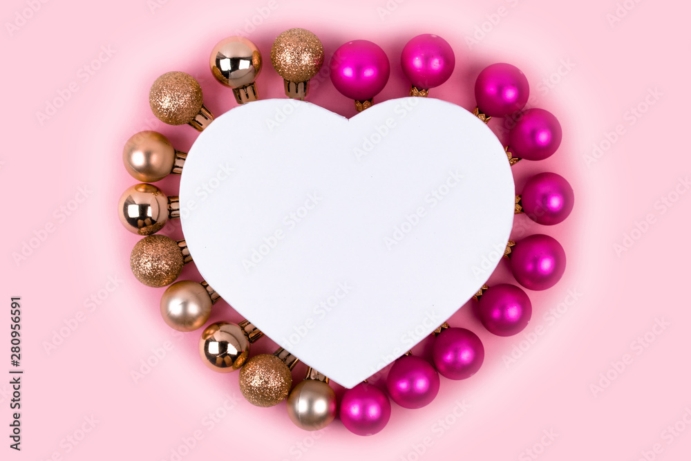 Obraz premium Christmas pink and gold balls with gift box on pink background. Christmas gifts and decoration on white background with copy space for text. 