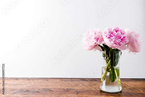Fototapeta Naklejka Na Ścianę i Meble -  beautiful pink peony flowers bouquet in glass vase
