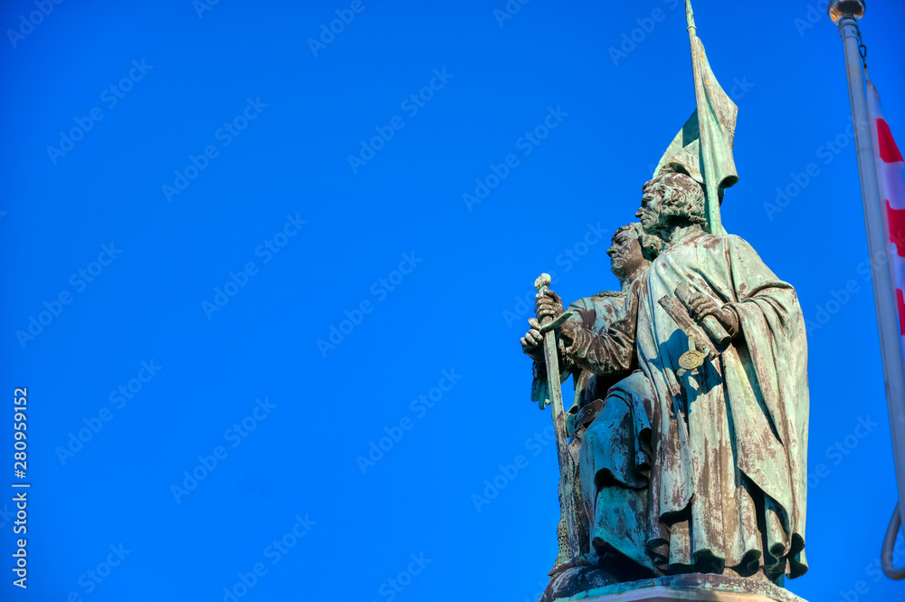 Fototapeta premium The Jan Breydel and Pieter de Coninck statue located in the historical city center and Market Square (Markt) in Bruges (Brugge), Belgium on a sunny day.