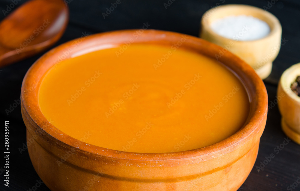 Pumpkin soup served on the table in bowl Pumpkin soup served on the table in bowl