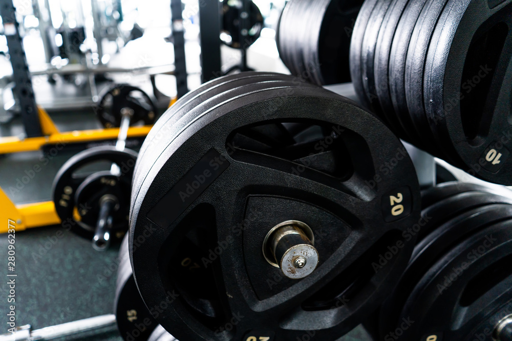 Modern light gym. Sports equipment in gym. Barbells of different weight on rack. Modern light gym. Sports equipment in gym. Barbells of different weight on rack.