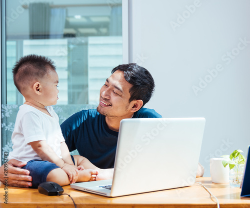 Man father working on laptop computer