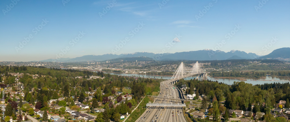 Aerial panoramic view of Trans Canada Highway near the Port Mann Bridge during a sunny morning. Taken in Surrey, Vancouver, BC, Canada.