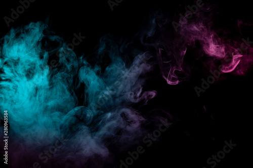 Colored background with winding clouds of smoke from patterns of different forms of pink, green and blue colors with tongues of flame on a black isolated background. Print for t-shirt.