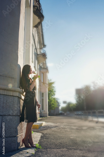 portrait of a beautiful girl on the background of the urban landscape