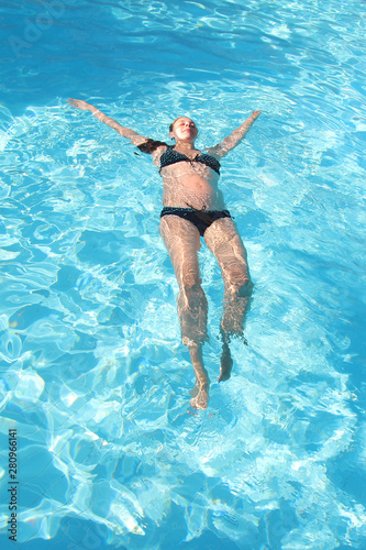 pregnant woman on vacation in the pool. The concept of Spa  swimming lessons  vacations  water treatment  IVF