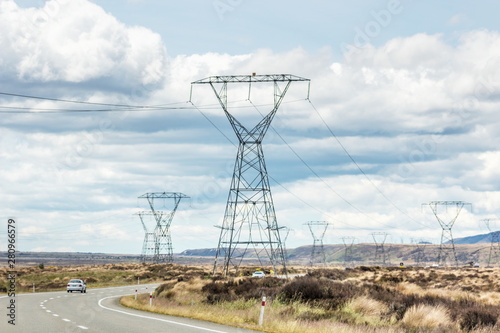 A car traveling through Rangipo Desert, a barren desert-like environment in New Zealand, located in the Ruapehu District on the North Island Volcanic Plateau.