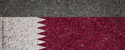 National flag of Qatar on a stone background.The concept of national pride and symbol of the country.