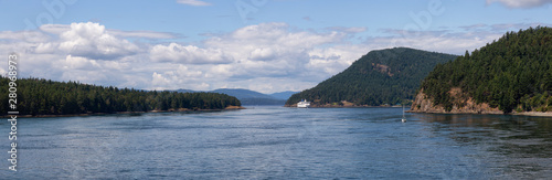 Beautiful Panoramic View of a Ferry Boat passing in the Gulf Islands Narrows during a sunny summer day. Taken near Vancouver Island, British Columbia, Canada.