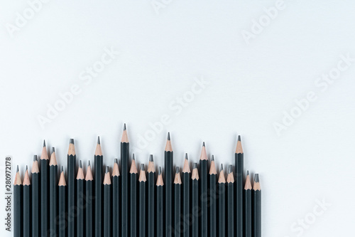 set professional black slate pencil for drawing lies on white cardboard background. Copy space. Mock ap.