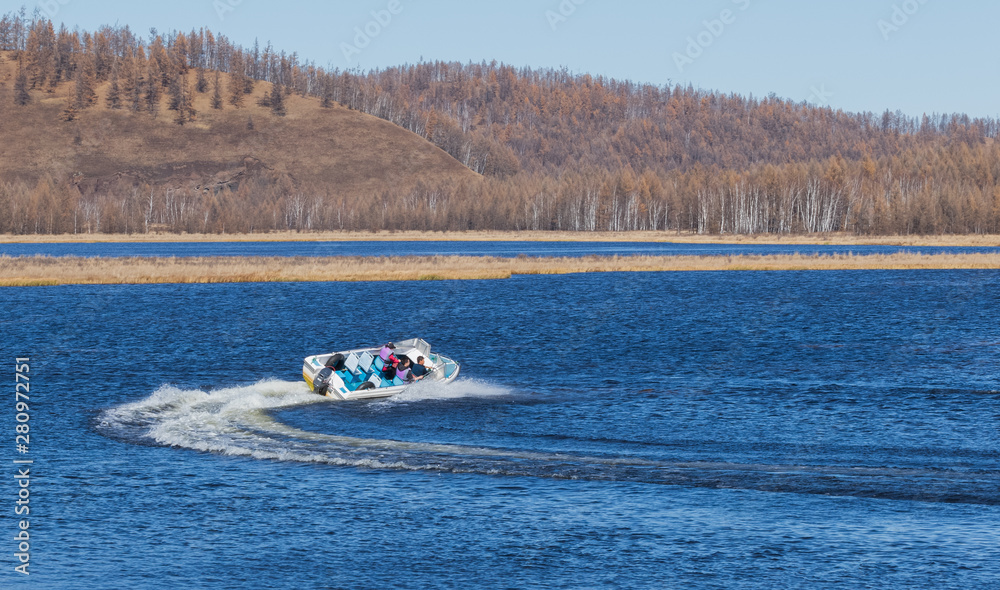 Fototapeta premium On the waters of the holiday lake, there are speedboats for tourists.