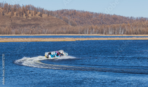 On the waters of the holiday lake, there are speedboats for tourists.