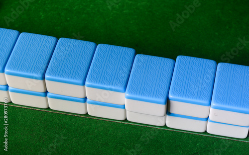 Mahjong game on green table photo