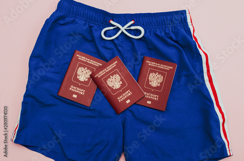 three Russian passports are on blue shorts