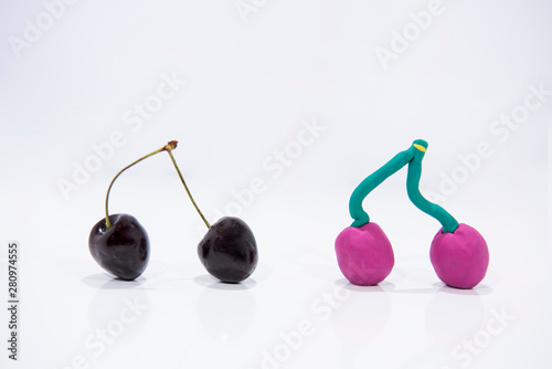 Comparison of two cherries - Real and Fake. photo