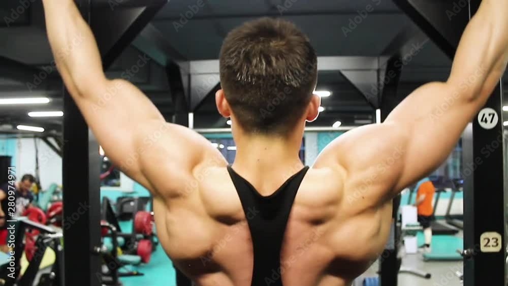 bodybuilder shows the muscles of the back when tightening bodybuilder shows the muscles of the back when tightening