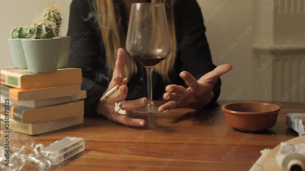 Girl woman with wine glass and cigarette at table speak talk stories, nervous tired