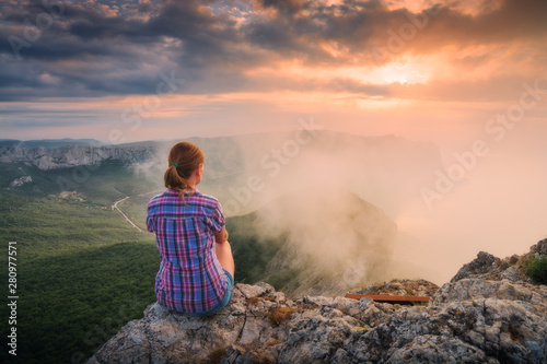 Young girl on a cliff