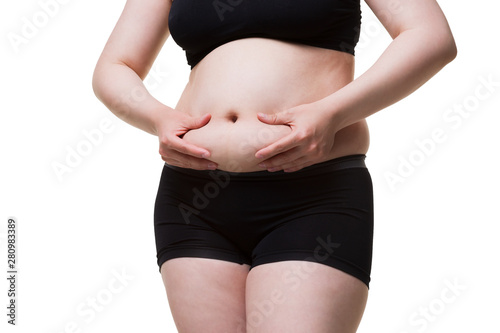Tummy tuck, flabby skin on a fat belly, plastic surgery concept © staras