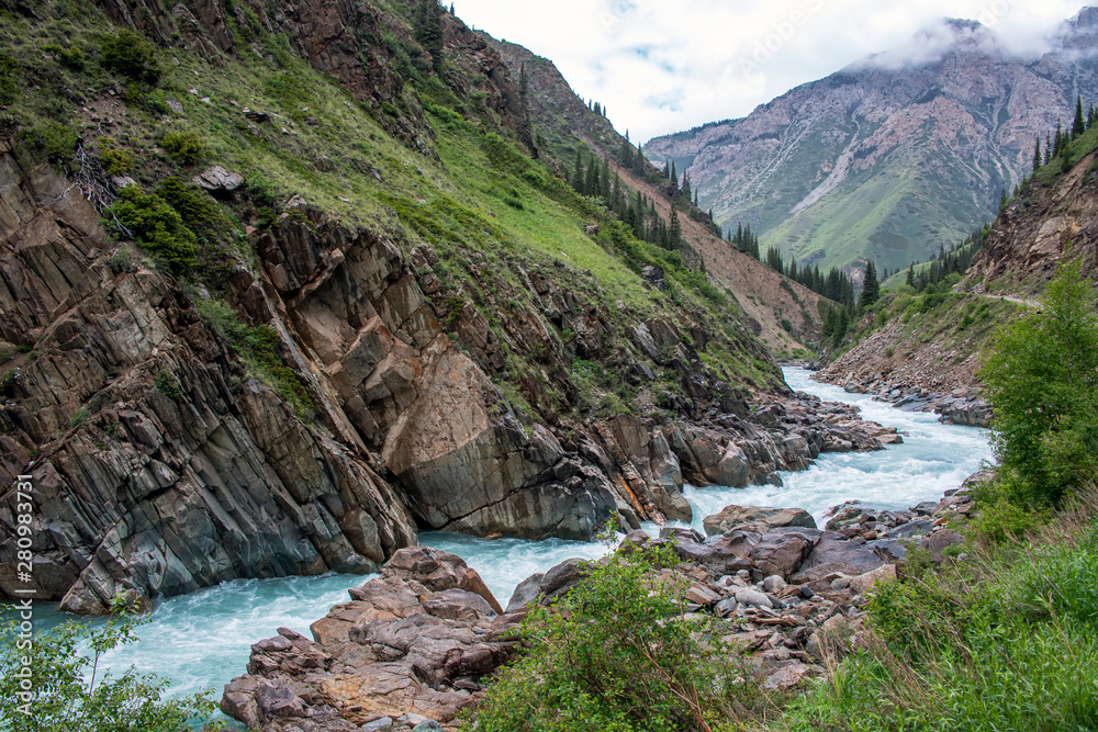 View of the Naryn River flowing through a mountain gorge View of the Naryn River flowing through a mountain gorge