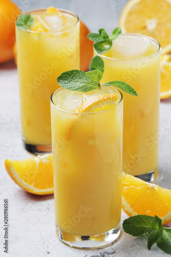 Glasses full of orange juice with ice	