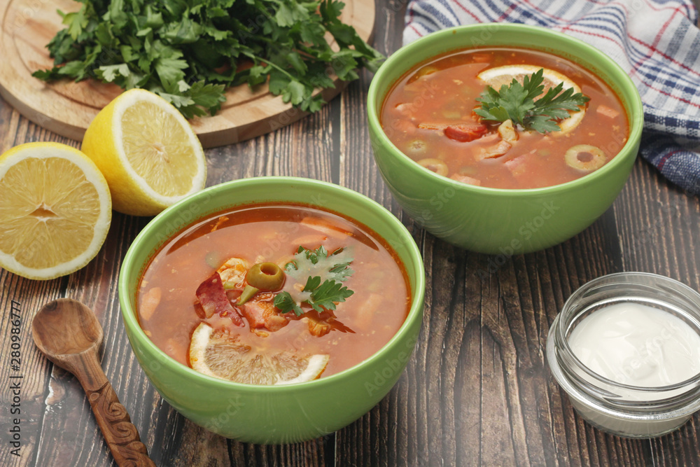 Two bowls with traditional Russian soup solyanka Two bowls with traditional Russian soup solyanka