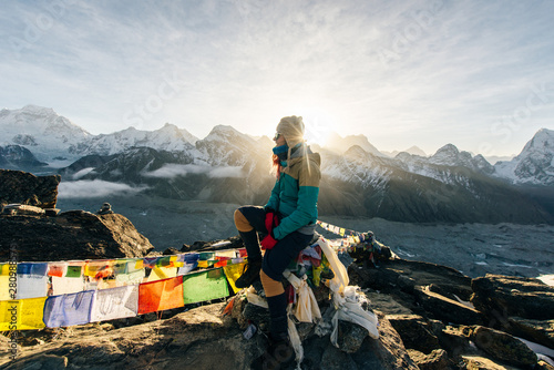 Female Tourist Hikking at gokyo ri mountain peak near gokyo lake during Everest base camp trekking in nepal