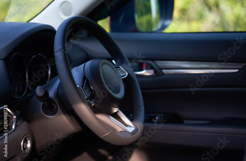 Vehicle interior of a modern car with steering wheel © jamesteohart