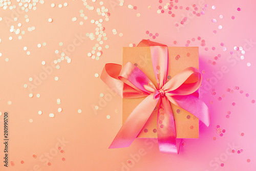 Christmas, birthday, wedding neon card with gift box bow on pink and  background © Denira