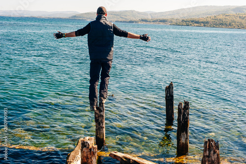 man on Rock on Olkhon Island in Lake Baikal, Russia photo