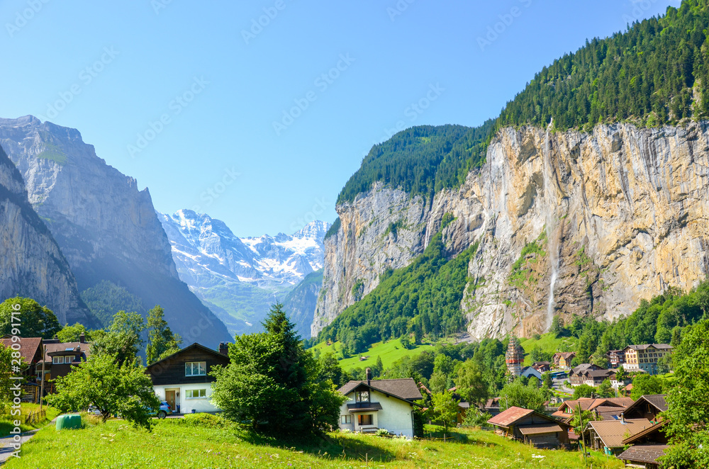 Amazing view of picturesque Lauterbrunnen village with famous Staubbach Falls in background. Popular tourist destination in Switzerland. Summer season, Swiss Alps. Switzerland landscape