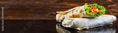 Delicious shawarma sandwich on wooden background. Banner.