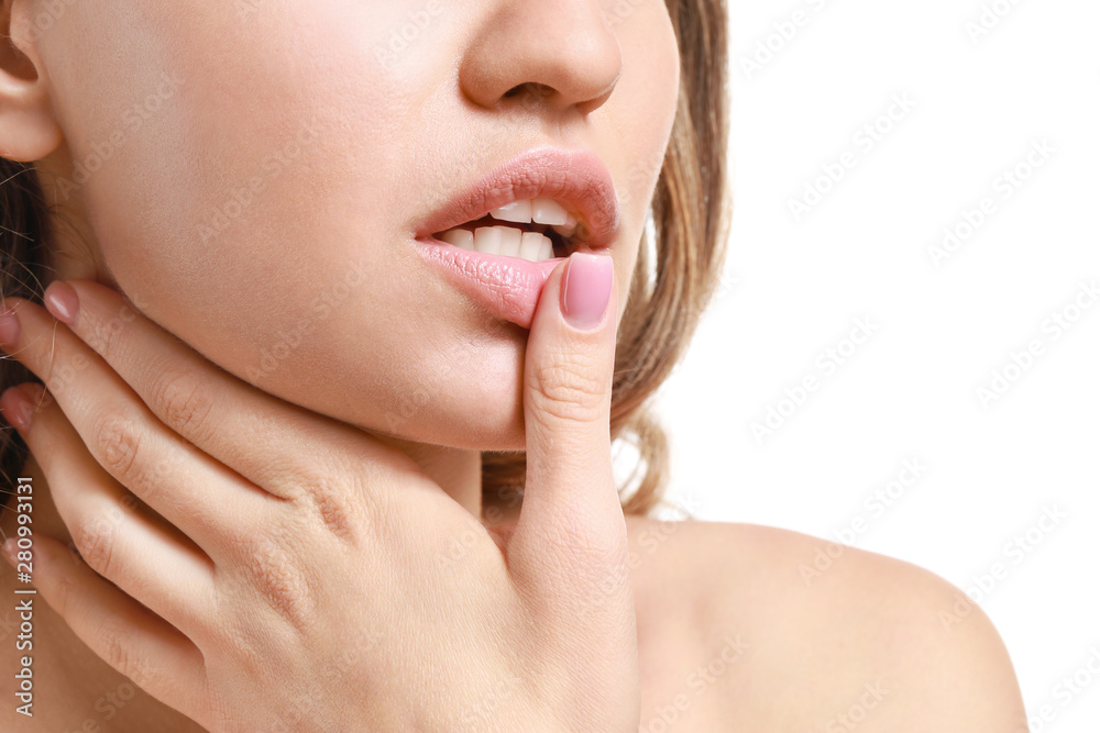 Fototapeta premium Young woman with beautiful lips on white background, closeup