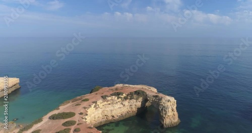 Aerial seascape in Praia Albandeira, popular beach destination of Algarve barlavento rocky cliff coast. South Portugal. photo