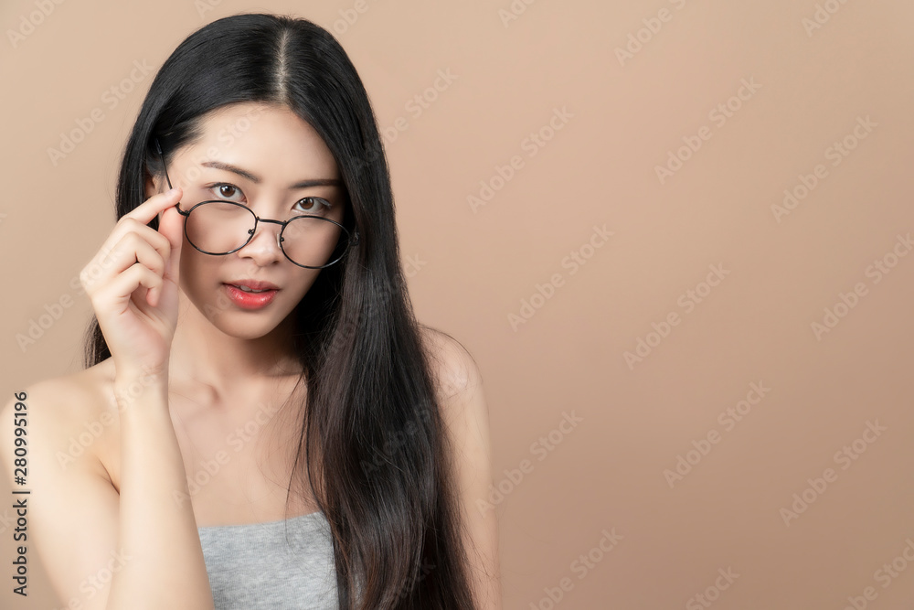 Pretty attractive  Asian woman holding her glasses. White background.