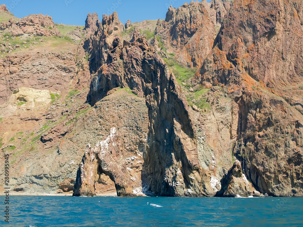 Coastal cliffs of volcanic origin on the sea shore